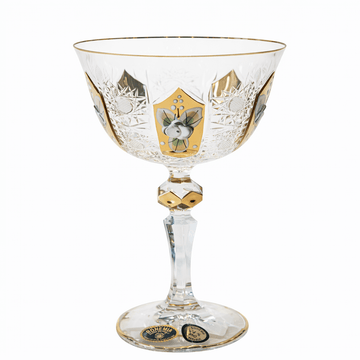 Decorative glass goblet with gold and black designs on a white background