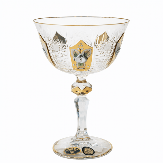 Decorative glass goblet with gold and black designs on a white background